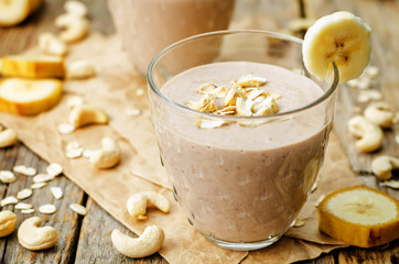 cashew banana cocoa oats smoothie on a wood background