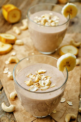 cashew banana cocoa oats smoothie on a wood background