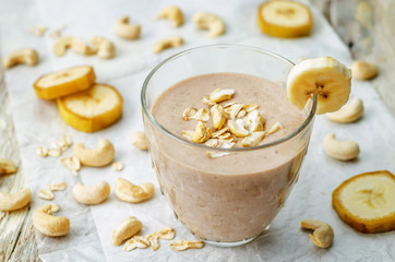 cashew banana cocoa oats smoothie on a wood background