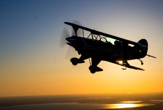 Biplane At Sunset