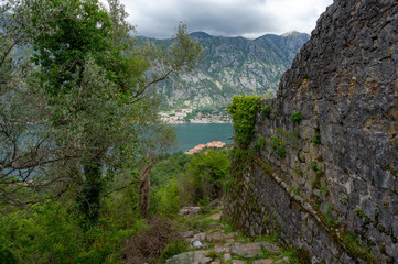 Bay of Kotor from the heights. View from Mount Lovcen to the bay. View down from the observation platform on the mountain Lovcen. Mountains and bay in Montenegro. The liner near the old town of Kotor.