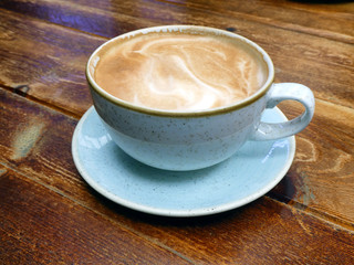 Cup of fresh coffee on wooden table