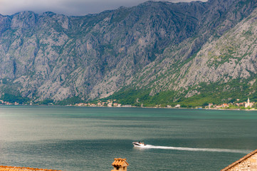 Bay of Kotor from the heights. View from Mount Lovcen to the bay. View down from the observation platform on the mountain Lovcen. Mountains and bay in Montenegro. The liner near the old town of Kotor.