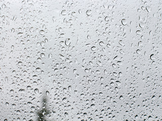 large drops of rain lie on the glass.blurred background