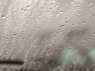 large drops of rain lie on the glass.blurred background