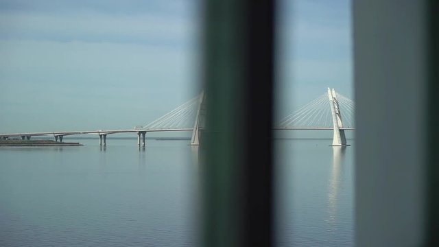Modern bridge over bay in sunny day