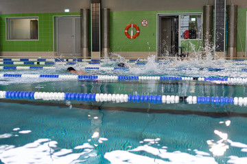 Fototapeta na wymiar Swimming pool with blue and transparent water. Competition at a sports event.