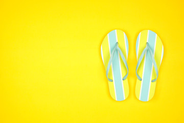 Summer flip flops on a yellow background. Summer vacation concept. Top view with copy space.