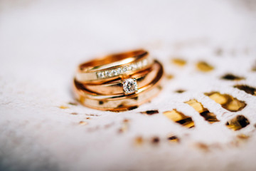 wedding rings with beautiful carvings on the sand background
