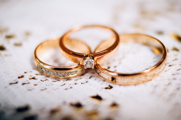 wedding rings with beautiful carvings on the sand background