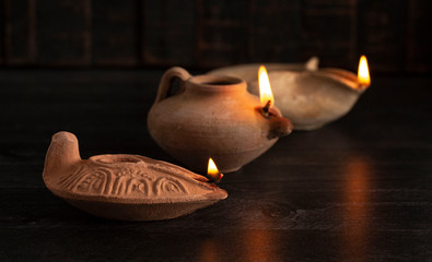 Lit Handmade Oil Lamp from the Middle East on a Dark Table