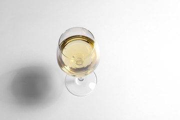 Glass of wine on white background, above view. Space for text