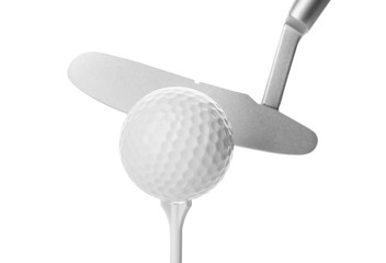 Hitting golf ball on tee with club against white background