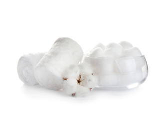Fototapeta na wymiar Fluffy cotton rolls, balls and flower on white background