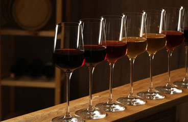 Glasses of different wines in cellar. Expensive collection