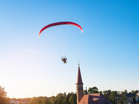 Powered parachute against the blue sky. 