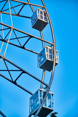 Ferris wheel in an amusement park close up