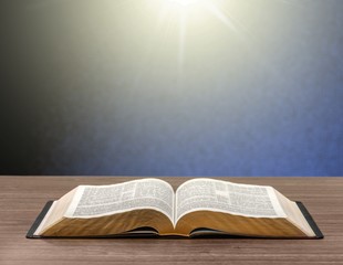 Open book on old wooden table
