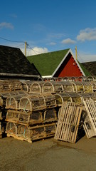 fishing traps stacked in front how buildings