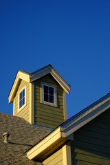 Fototapeta na wymiar steeple and roofline with blue sky vertical