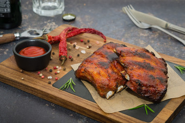 Grilled pork ribs on wooden board. Smoked barbecue pork spare ribs 