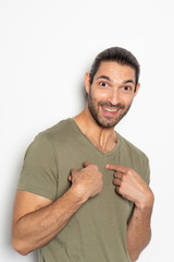 Expressive young man on white background pointing at himself