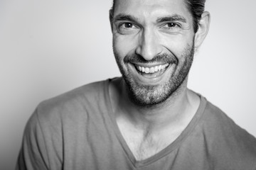 BW portrait of a caucasian young man smiling at the camera