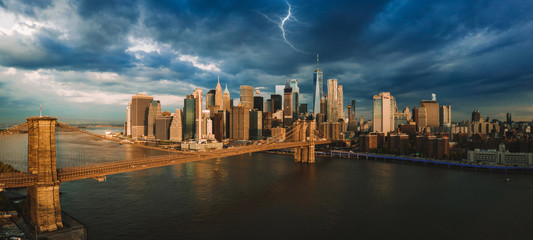 Panorama of the lightning over Manhattan island and Brooklyn bridge during stormy sunset. Epic...