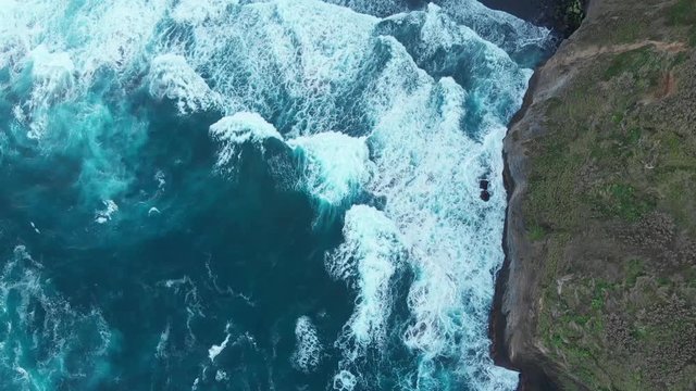 Aerial Drone Azores Portugal flyover waves and blue sea black rocks green mountains