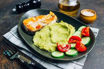 Cherry tomatoes, cucumber, mashed broccoli, salmon steak. Keto lunch.