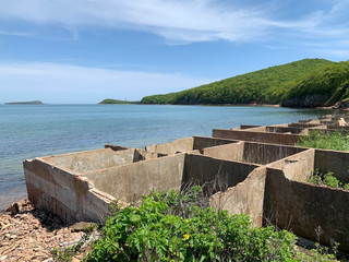 Russia, Vladivostok, the island of Shkot. Remains of concrete tanks for salting fish