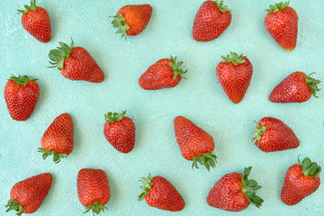 Ripe strawberries on a bright blue background. Fresh fruits pattern. Fruit background. Top view