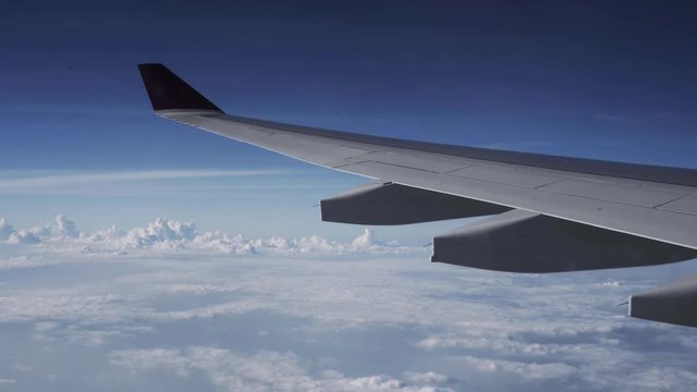 BEAUTIFUL AERIAL VIEW OF CLOUDS SKY FROM AIRPLANE, with wing cover one third of image on top right 
