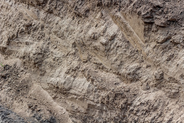 The texture of clay soil with traces of the excavator bucket