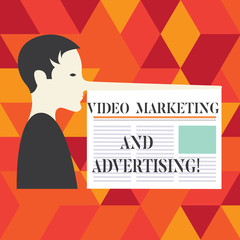 Writing note showing Video Marketing And Advertising. Business photo showcasing Promotion campaign optimization strategy Man with a Very Long Nose like Pinocchio a Blank Newspaper is attached