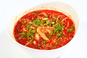 Vermicelli red hot soup in white porcelain bowl