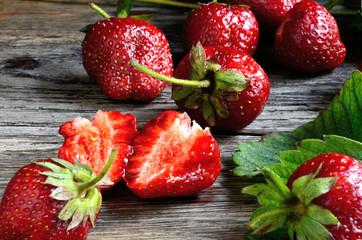 Harvest strawberries from the garden beds on the old board.