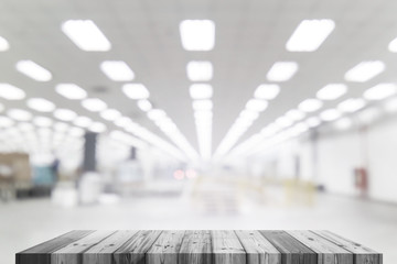 Wood table in factory building blurred background