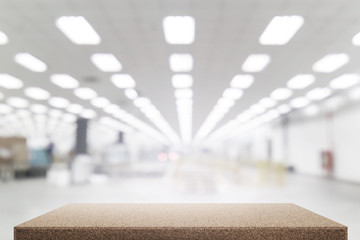 Wood table in factory building blurred background