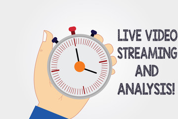 Naklejka premium Handwriting text writing Live Video Streaming And Analysis. Concept meaning Marketing advertising content strategy Hu analysis Hand Holding Mechanical Stop Watch Timer with Start Stop Button