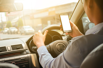 Man use smartphone in the car on the road
