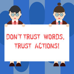 Handwriting text Don T Trust Words Trust Actions. Concept meaning Less talking more things done action taken Male and Female in Uniform Standing Holding Blank Placard Banner Text Space