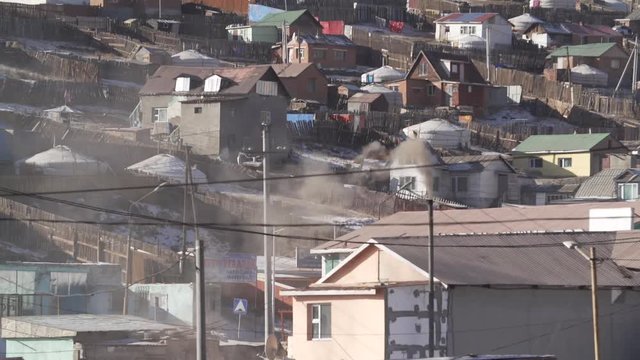 Smoke comes from chimney in ger neighbourhood of Ulaanbaatar, Mongolia. Medium.