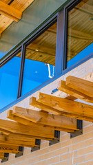 Vertical frame Building with decorative woods extending horizontally from the brick wall