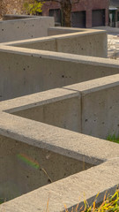 Vertical Concrete blocks on a grassy terrain at the side of a road in Salt Lake City