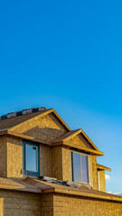 Vertical frame Exterior of a house under construction lit by sunlight on a sunny day