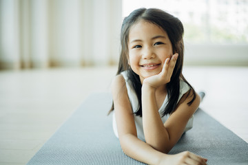 Portrait Asian little girl in living room smiling and happy