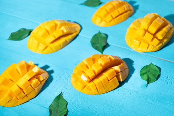 Exotic mango tropical fruit cutted on blue background