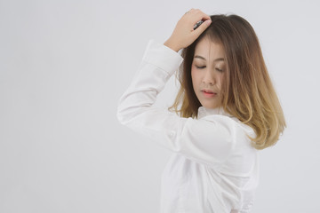 Fototapeta premium Portrait of young asian beautiful woman against white background. Half body of female in white shirt ; free from copy space.