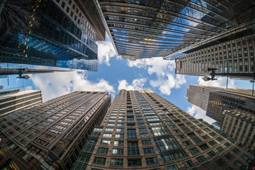 Fototapeta na wymiar Uprisen angle with fisheye scene of Downtown Chicago skyscraper with reflection of clouds among high buildings, Illinois, United States, Business and Perspective concept